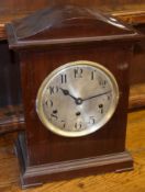 Mahogany cased mantel clock with German movement, circular Arabic chapter ring and bracket feet,