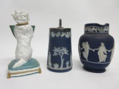 Two Wedgwood blue jugs and a further novelty model of a white glazed dog holding a basket in his