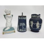 Two Wedgwood blue jugs and a further novelty model of a white glazed dog holding a basket in his