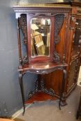 Mahogany mirror back corner whatnot, crested with a brass gallery over a mirror with open shelf