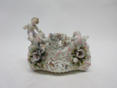 Late 19th century Continental porcelain basket with flower encrusted decoration and a cherub to