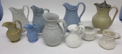 Group of late 19th century relief moulded pottery jugs of various decoration and makers including