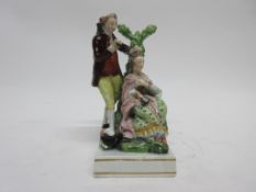 Early 19th century pearlware group of a couple en toilette on square base. Note: for a Derby