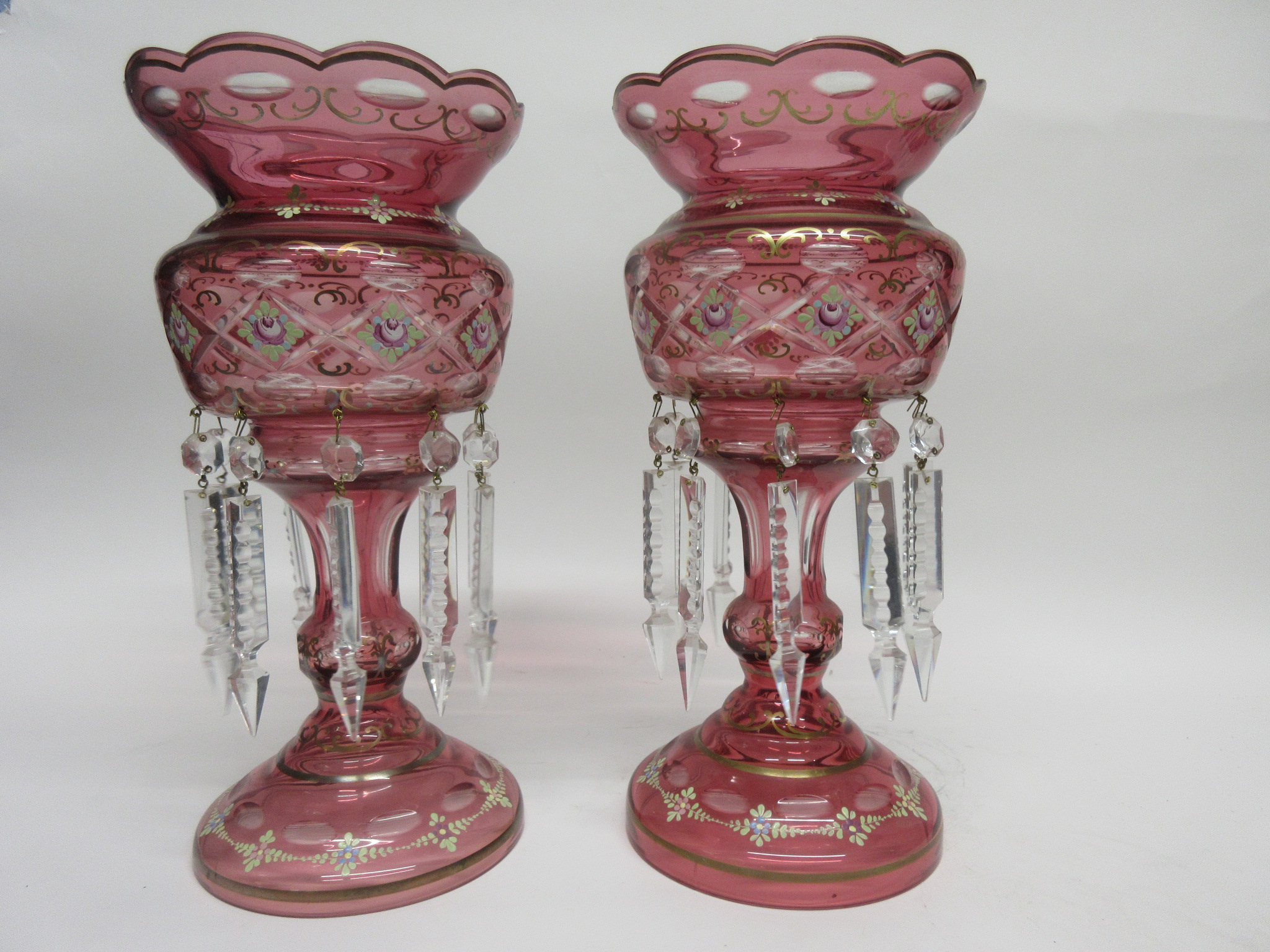 Pair of pink glass table lustres with floral and gilt decoration, 33cm high (2)