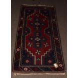 Caucasian style small wool carpet, central cruciform lozenges, single gull border, mainly red and