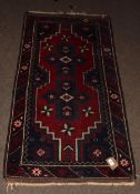 Caucasian style small wool carpet, central cruciform lozenges, single gull border, mainly red and