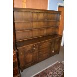 Reproduction Reprodux oak dresser, plate rack back over base fitted with three central drawers