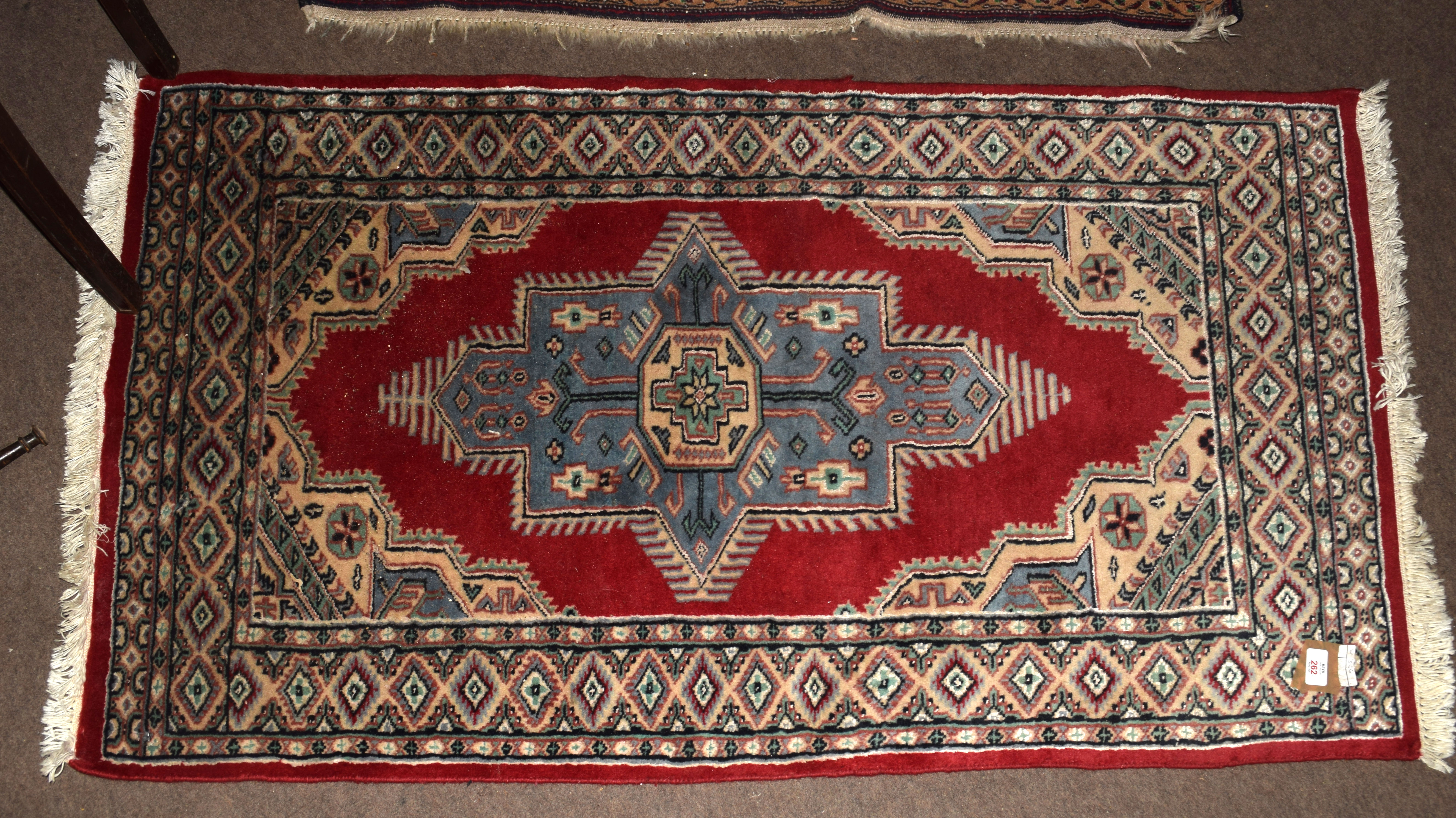 Late 20th century Oriental rug, central cruciform type design, mainly red and beige field, 76 x