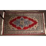 Late 20th century Oriental rug, central cruciform type design, mainly red and beige field, 76 x