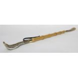 Wooden shoe horn with back stretcher at one end in plastic holder