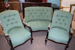 Late 19th century dark stained three piece cottage suite comprising a two-seater sofa and two
