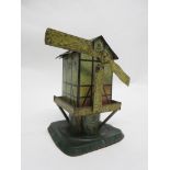 Vintage tin plate clockwork windmill, by S G (Germany) (one sail missing), 17cm high