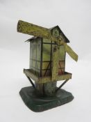 Vintage tin plate clockwork windmill, by S G (Germany) (one sail missing), 17cm high