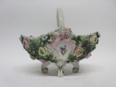 Continental porcelain flower basket on four scroll feet, the sides decorated with flower heads in