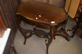 Edwardian mahogany two-tier occasional table of oval form with pie-crust edge, 65cm long