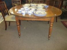 Large oak drop leaf dining table raised on ring turned supports with casters, 157cm wide