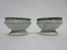 Pair of English porcelain table salts, the ribbed body with blue and white design to interior,