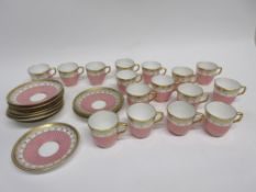 Group of late 19th century Minton coffee cups and saucers decorated in a pink and gilt design,