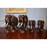 Two pairs of mid-20th century African ebony elephants, 18 and 26cm high respectively (4)
