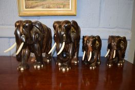 Two pairs of mid-20th century African ebony elephants, 18 and 26cm high respectively (4)