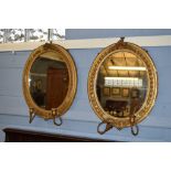 Pair of Victorian oval gilt gesso girandoles, each applied with two sconces (in need of repair),