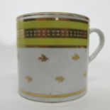 Coalport style coffee can with a yellow and gilt design, height 6cm high