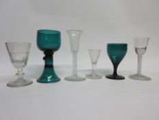 Two 18th century air-twist wine glasses together with two further green coloured wine glasses plus