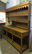 Oak dresser, plate rack back fitted with three shelves, the lower section with three frieze