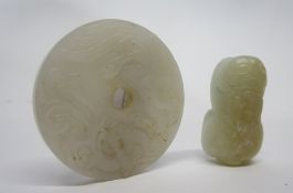 Chinese jade model of a cat, the white jade with russet occlusions, together with a circular disc