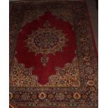 Caucasian style carpet with central lozenge, mainly red field, 126 x 183cm