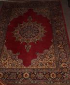 Caucasian style carpet with central lozenge, mainly red field, 126 x 183cm