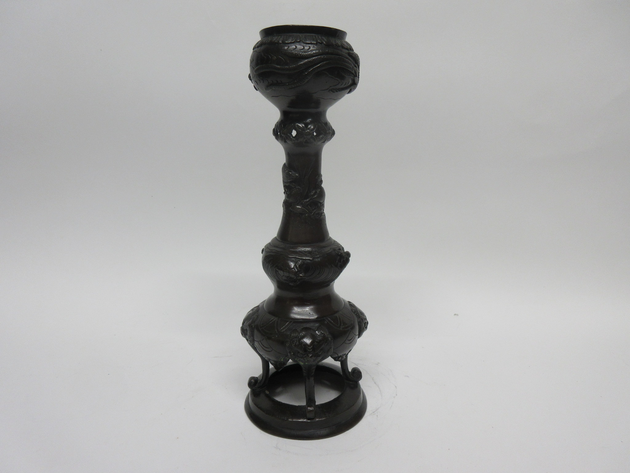 Oriental bronze candlestick with applied decoration of turtles and dragons, 31cm high