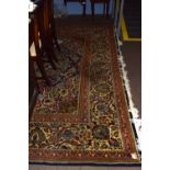 Large Caucasian style wool carpet, multi-gull border, central panel of flowering foliage, mainly