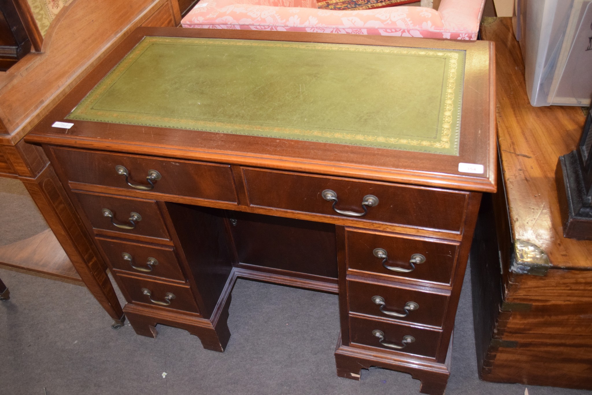 Reproduction small mahogany twin pedestal desk with gilt green tooled leather inset, two frieze