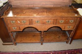 Small oak dresser base, frieze fitted with five drawers on ring turned front supports with shelf