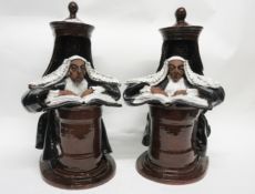 Pair of 20th century pottery book ends, the terracotta bodies brown glazed modelled as judges seated