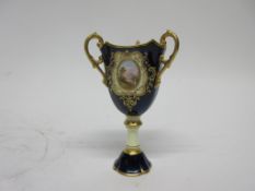 Coalport porcelain chalice, the blue ground with three gilt handles and gilt decoration including