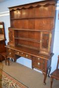 19th century oak dresser, the plate rack back fitted with two cupboards over short drawers and the