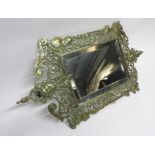 Victorian brass framed small rectangular wall mirror, frame decorated with masks and dragons, 50cm