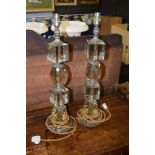 Pair of heavy glass electrified table lamps, all with faceted and balustered columns terminating