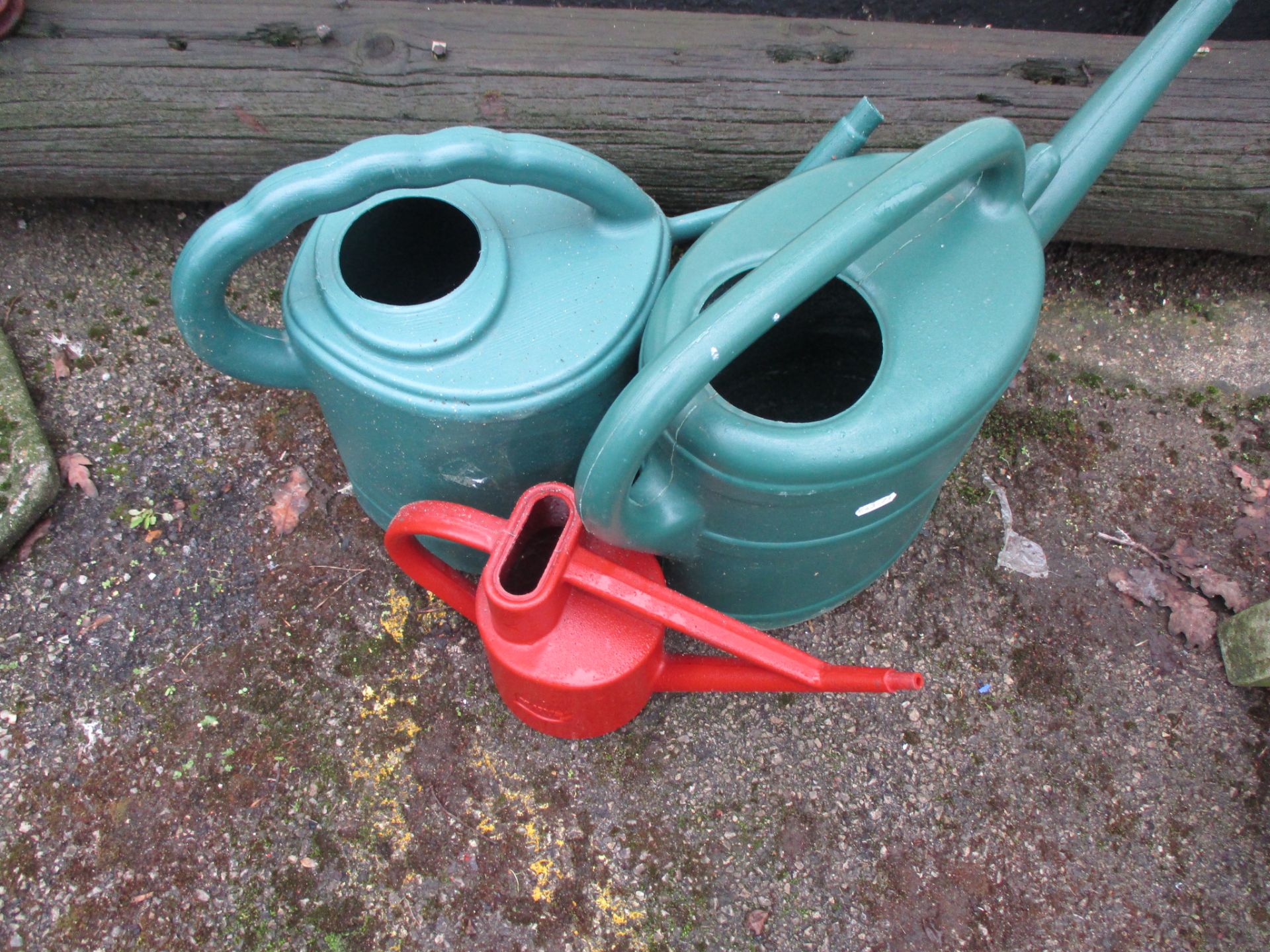 THREE PLASTIC WATERING CANS