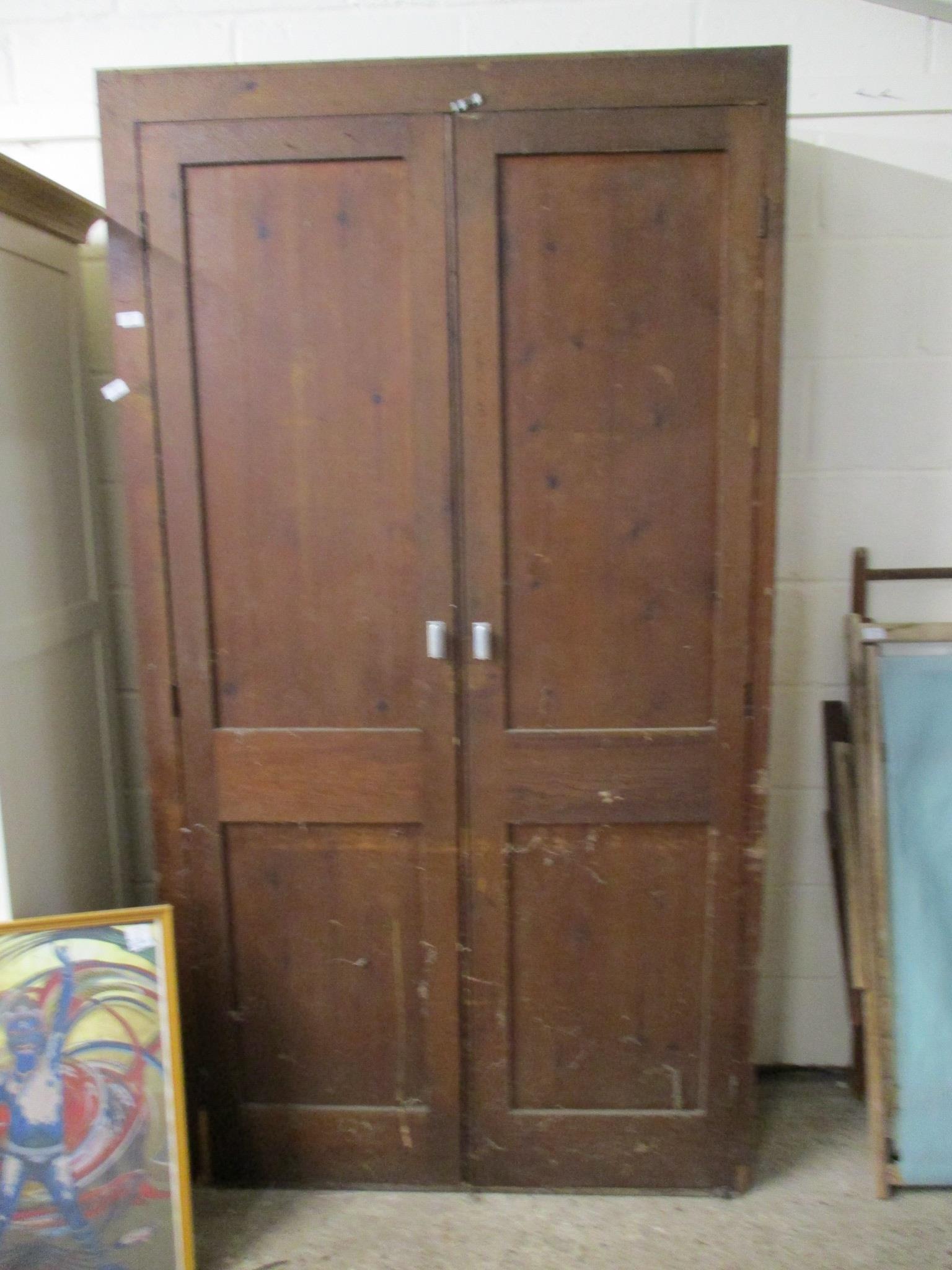 STAINED PINE AND PLY CUPBOARD WITH PANELLED DOORS, 114CM WIDE