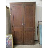 STAINED PINE AND PLY CUPBOARD WITH PANELLED DOORS, 114CM WIDE