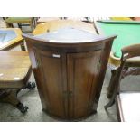 EARLY 19TH CENTURY OAK BOW FRONTED WALL MOUNTING CORNER CUPBOARD, 67CM WIDE