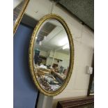 MODERN OVAL FRAMED GILT WALL MIRROR