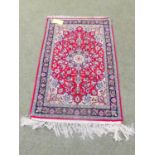 Persian made wool prayer mat with maroon ground & pale green/blue border decorated with floral motif