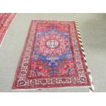 Eastern hand woven Asian wool rug with floral pattern on brown/ red ground 198 x 132cm