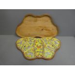 Butterfly shaped wooden boxed set of Chinese hors d'oeuvre dish with floral decoration on a yellow