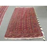 Quality handmade Asian wool rug decorated with a regular square pattern containing flowers & symbols