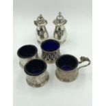 4 Sterling silver salts with blue glass liners, & a pair of silver pepperettes
